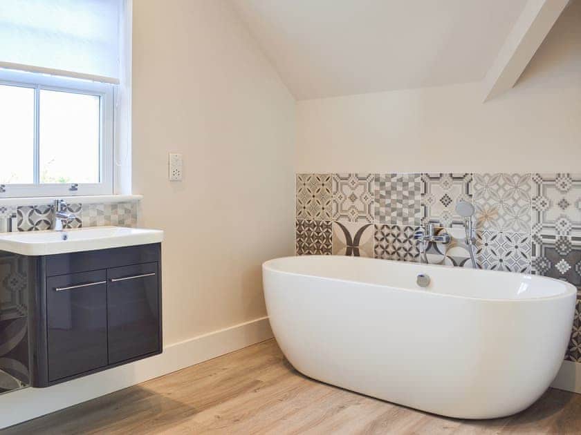 Stand alone contemporary bath with shower attachment | The Carriage House - Station House Cottages, Upper Poppleton, near York