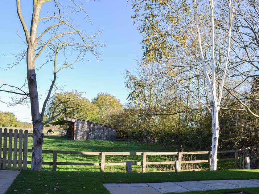 Lawned garden overlooking open fields | The Carriage House - Station House Cottages, Upper Poppleton, near York