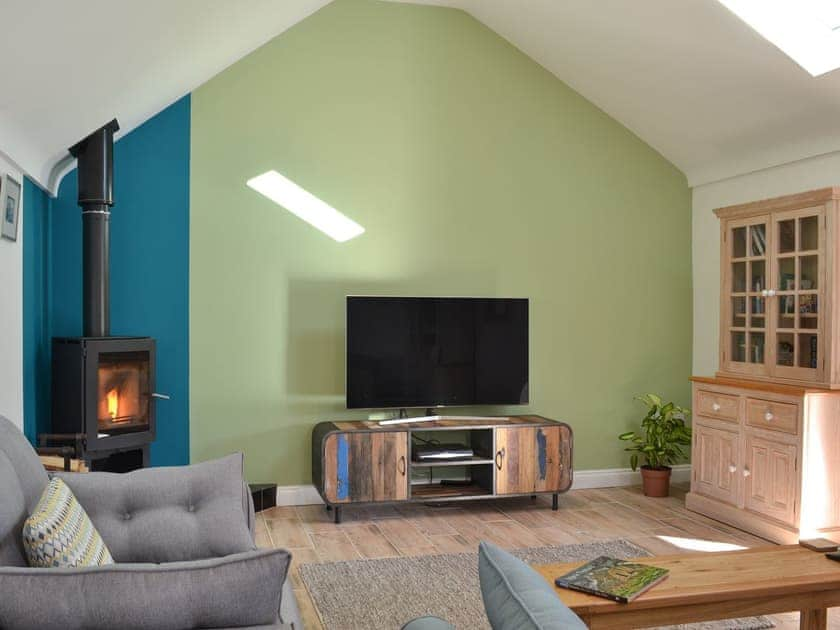 Living room with wood burner | 1 Barnagh Barn, Rhen Cullen, near Kirk Michael