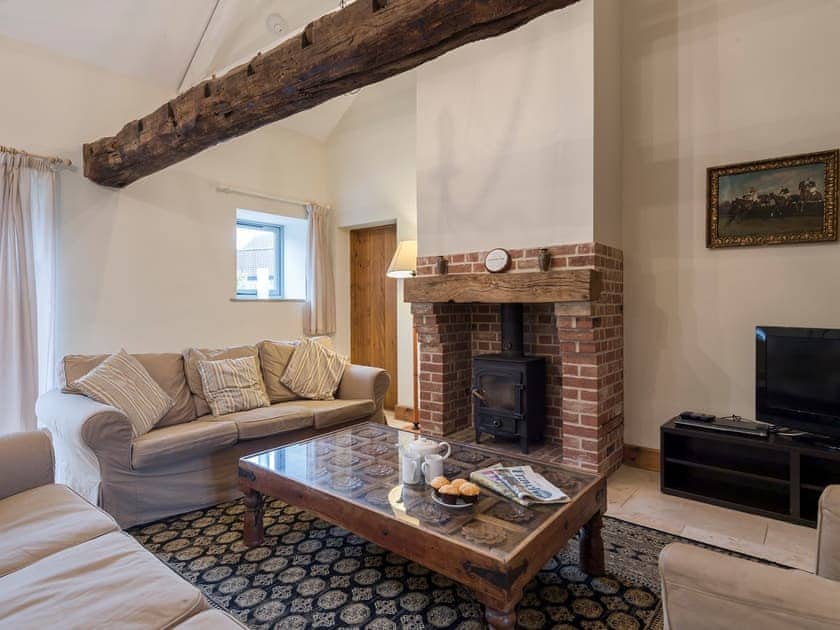 Cosy living area with wood burner | The Stables - Manor Mews, Tattersett, near Fakenham