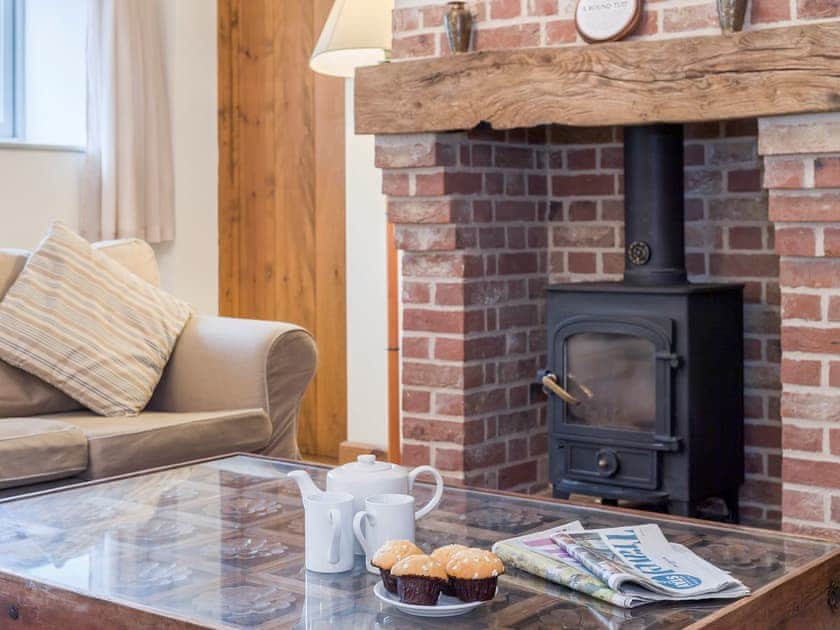 Cosy living area with wood burner | The Stables - Manor Mews, Tattersett, near Fakenham