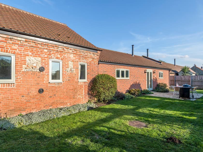 Enclosed lawned courtyard with sitting-out area, garden furniture and BBQ | The Stables - Manor Mews, Tattersett, near Fakenham