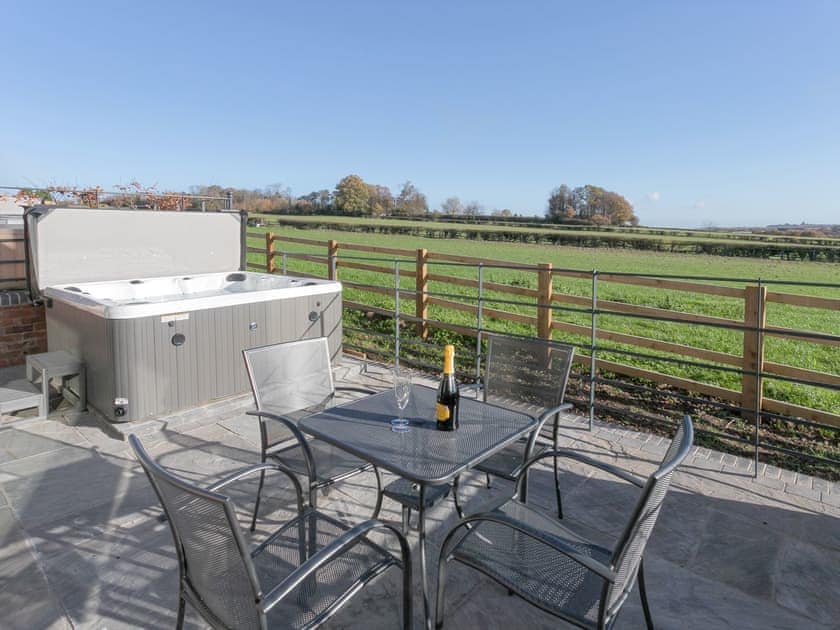 Patio area with outdoor furniture and hot tub | The Retreat - Broadstone Barns, Ticknall, near Derby