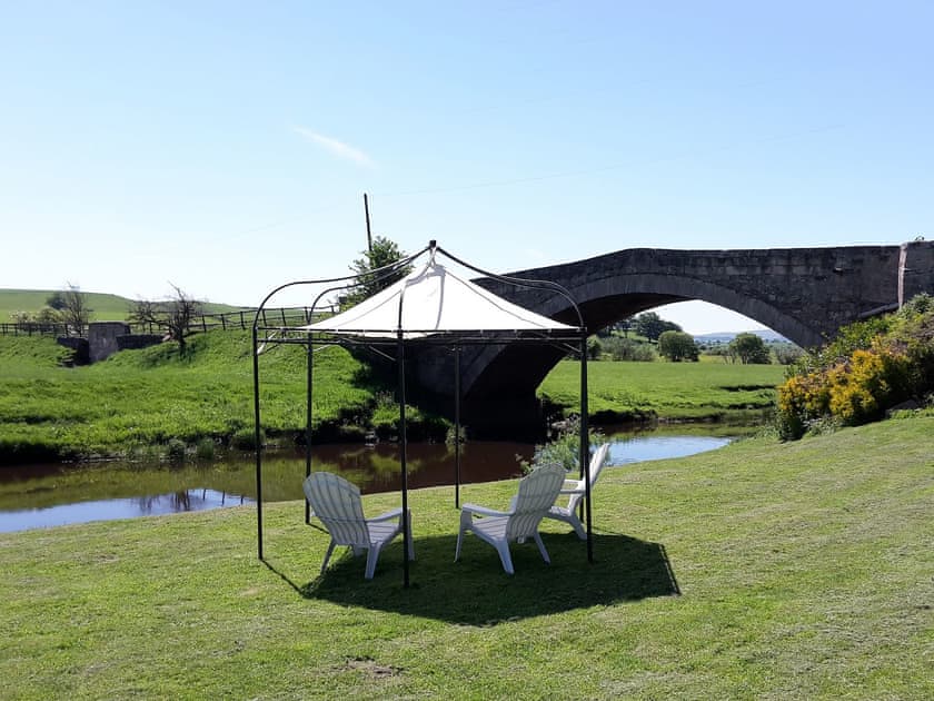 The bridge over Douglas Water from the lawn | Harperfield Chalet, Lanark