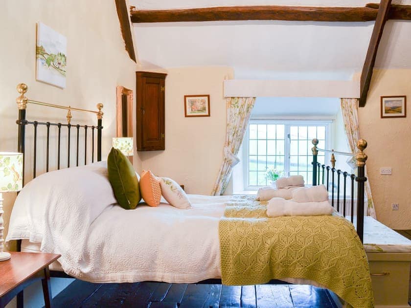 Charming double bedroom with antique style bed | West Hurscott Cottage, Hurscott, near Barnstaple
