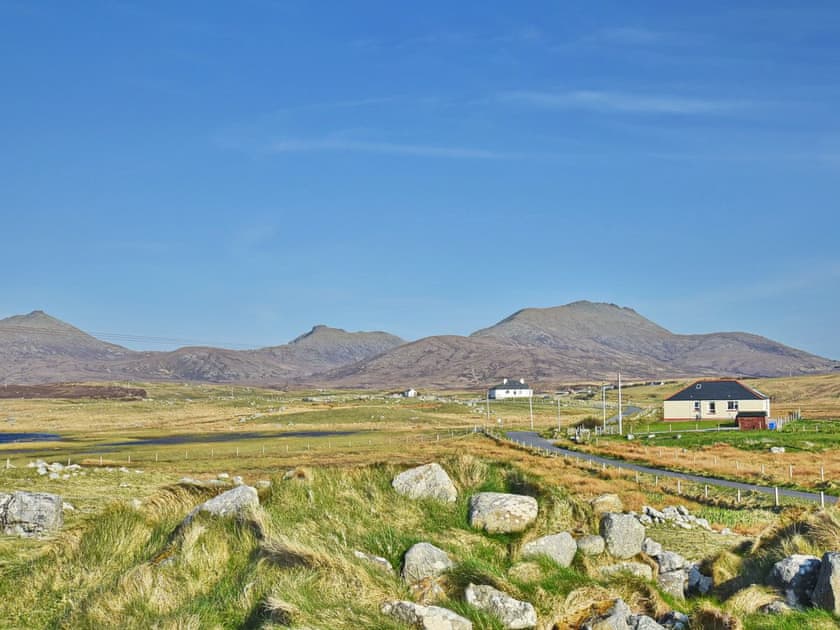 Sitting in the shadow of the formidable Hebridean hills | Padraig’s Cottage, Howbeg (Tobha Beag), Isle of South Uist