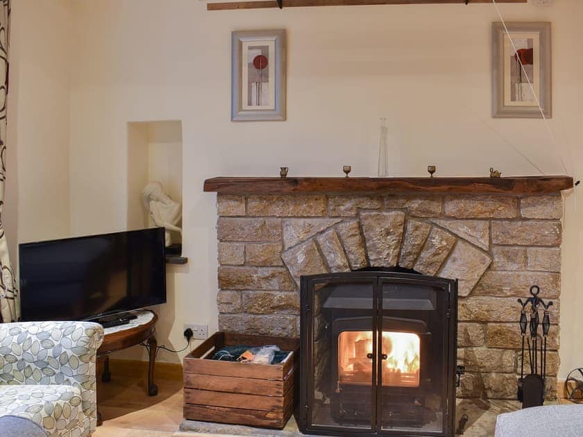 Living room with feature fireplace and wood burner | Ramshead Cottage, Tebay, near Kendal