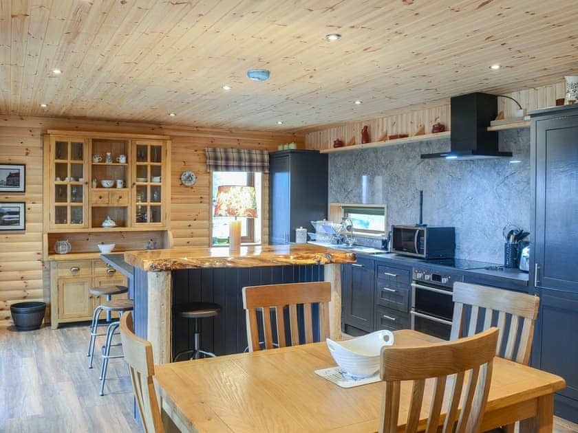 Modest dining area and adjacent kitchen | Red Kite Lodge, Osprey Lodge, near Dornoch