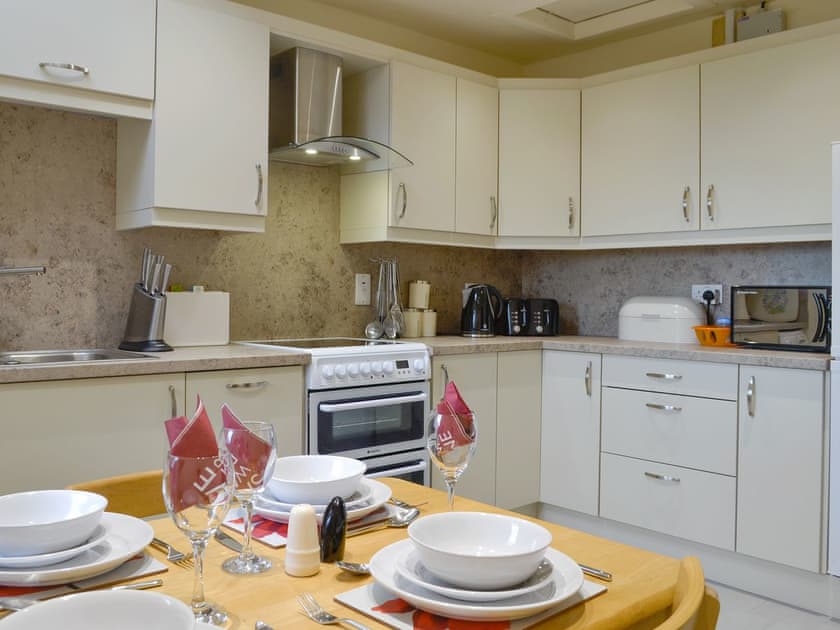 Fully appointed fitted kitchen with dining area | Mill Shore Cottage - Nethermill Cottages, Pennan, near New Aberdour