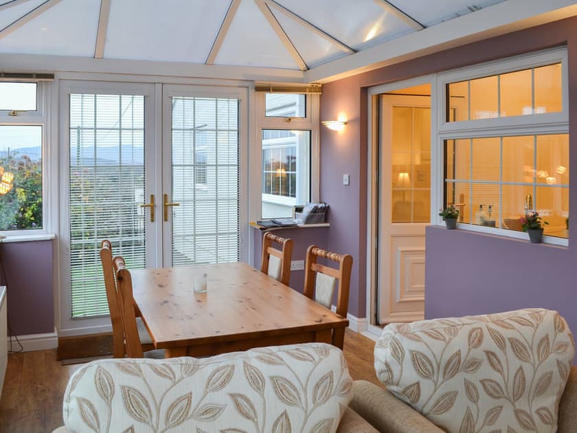 Living area with double doors to the garden | Ty Canol, Brynteg, Anglesey