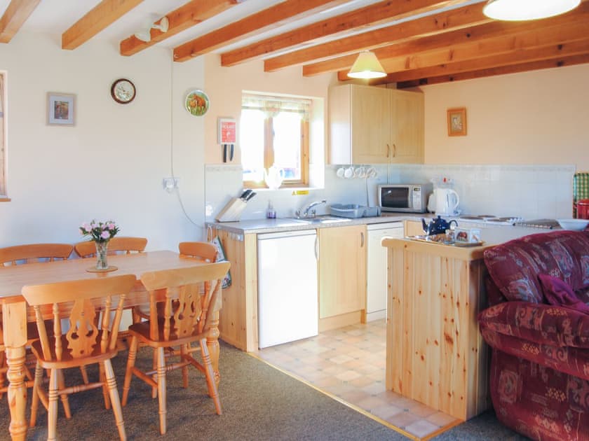 Lovely living area with farmhouse style dining table and chairs | Porth View - Higher Lanvean Farm, St Mawgan, near Newquay