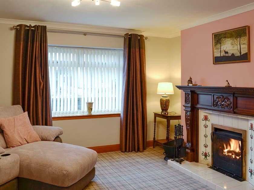 Comfortable living room with a cosy opne fire | Hawthorn Cottage, Stranraer