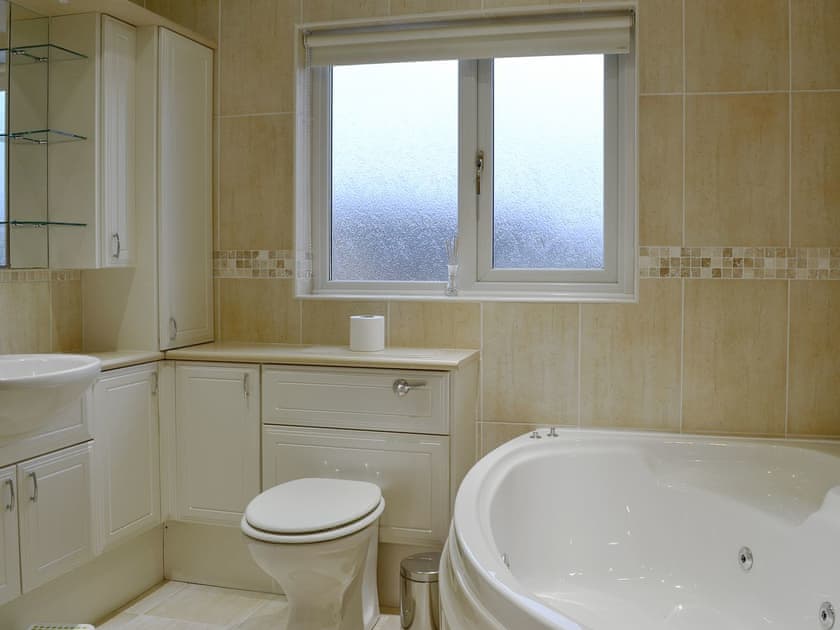 Bathroom with spa bath and shower cubicle | Hawthorn Cottage, Stranraer