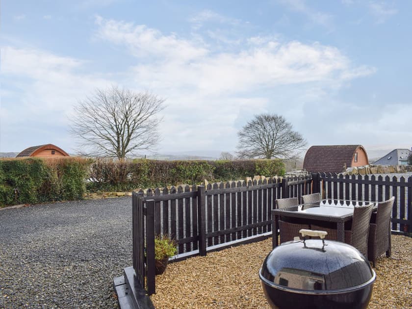 Private outdoor space with BBQ and table and chairs | The Plucking Barn, Llanwnnen, near Lampeter