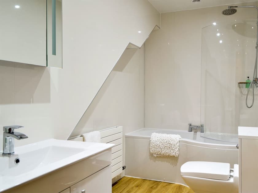 Bathroom with shower over the bath  | Seascape Cottage, Allonby, near Maryport