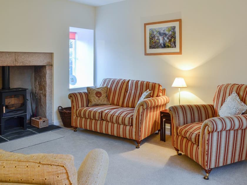 Comfortable living room with feature fireplace | Dairy Cottage, Whitehouse, near Alford