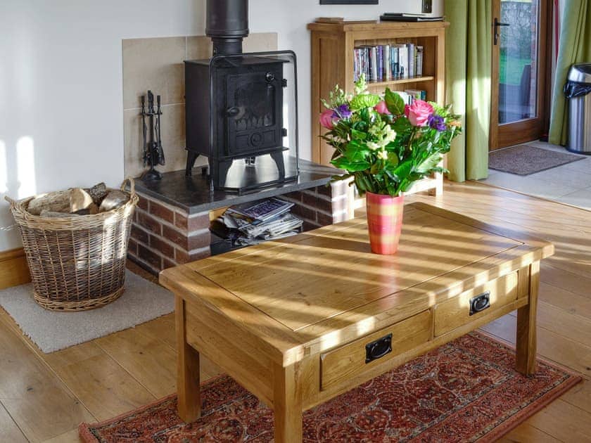 Welcoming living area with wood burner | Little Hendre Lodge - Old Hendre Farm, Wonastow, near Monmouth