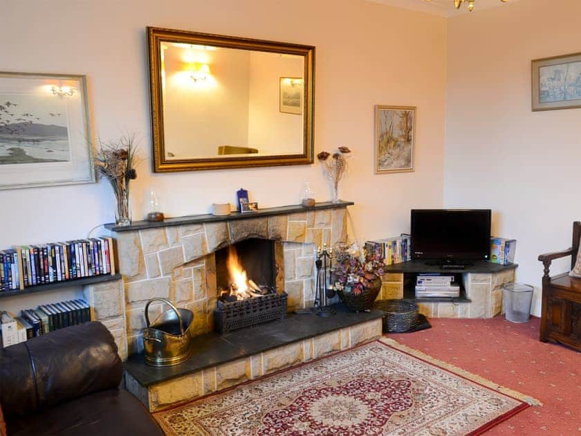 Comfortable living room with open fire | Culcharry Cottage, Cawdor, Nairn