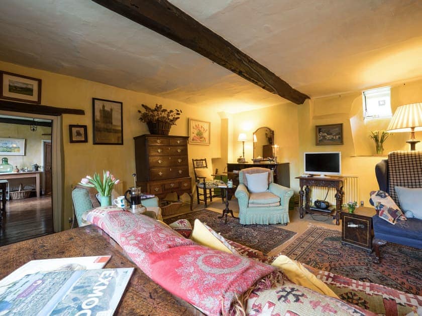 Cosy living room with wood burner | The Old Priory Cottage, Dunster, near Minehead
