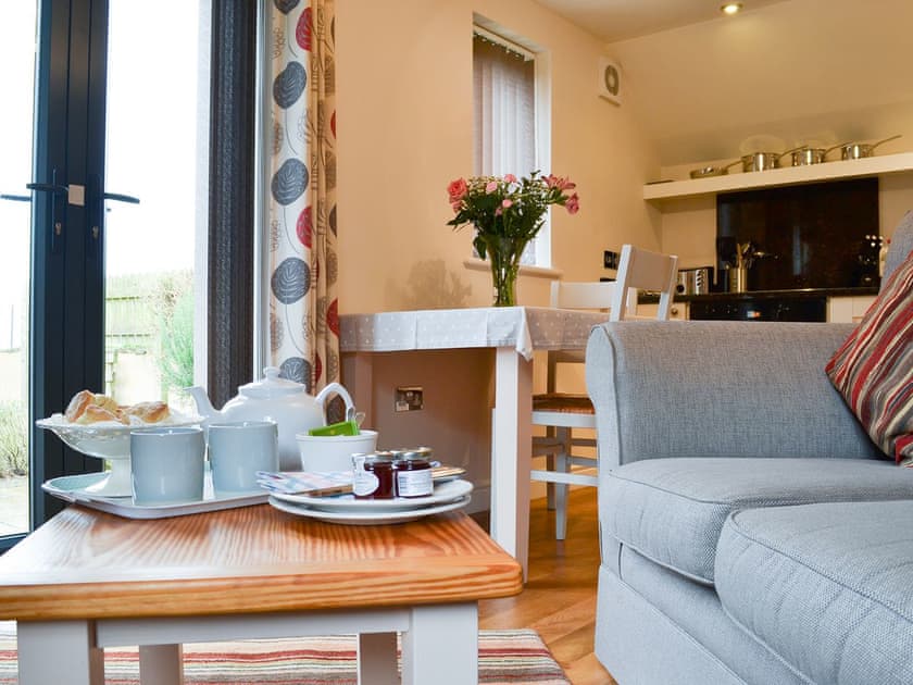 Lovely bright living area with French doors to the garden | The Bothy, Bradworthy, near Bude