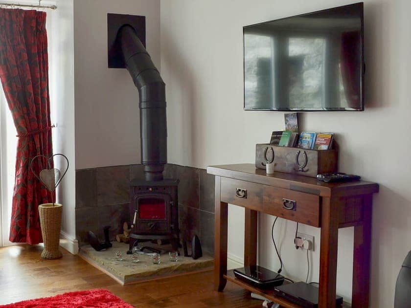 Comfortable  living room with wood burner | The Coach House, Greenodd, near Ulverston