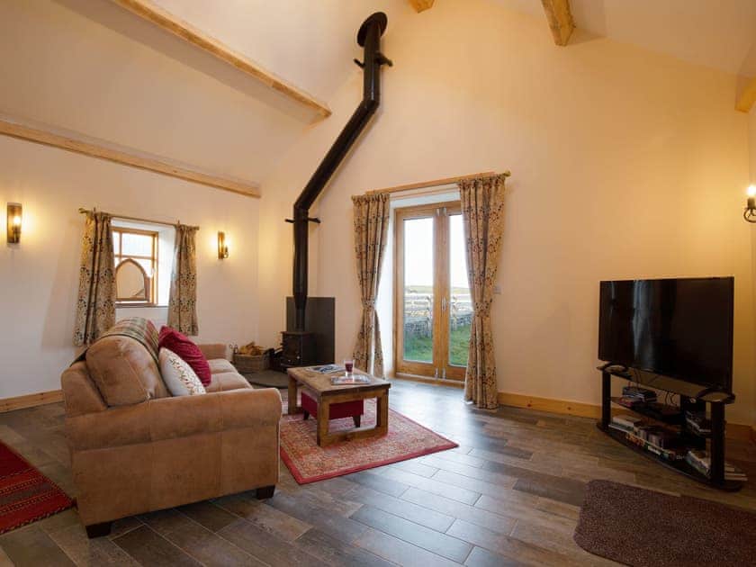 Stylish living room with wood burner | Curlew Cottage - Cerrig Cottages, Caergeiliog, near Rhosneigr