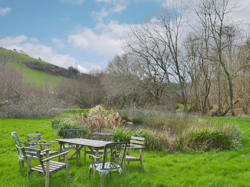 Sitting out area in the grounds (unfenced pond) | Willow Barn, Polmassick, near St Austell