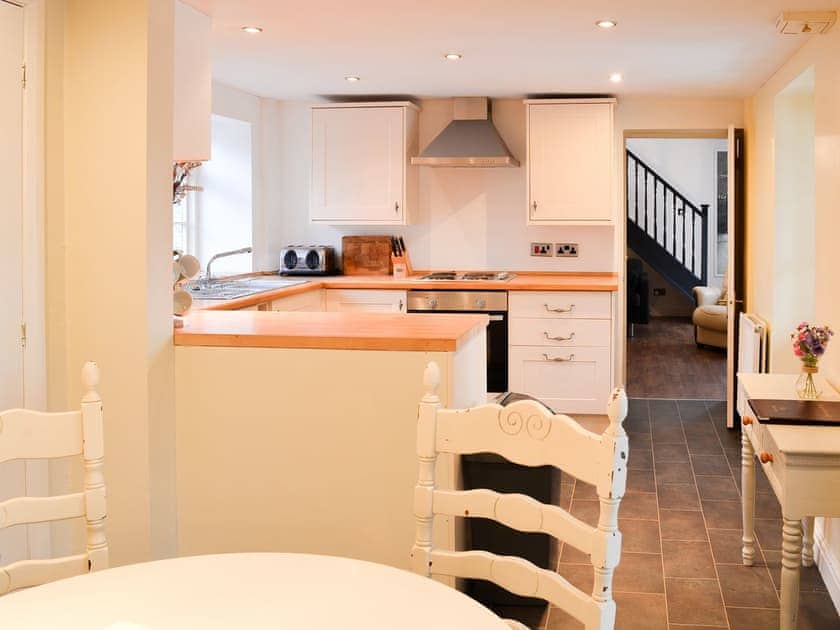 Dining area through the kitchen to the living room and stairs | Brewers Cottage, Cropton, near Pickering
