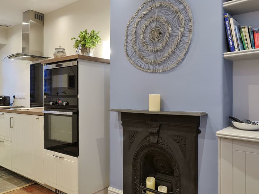 Feature fireplace within kitchen/diner | Riverholme, Bassenthwaite, near Keswick