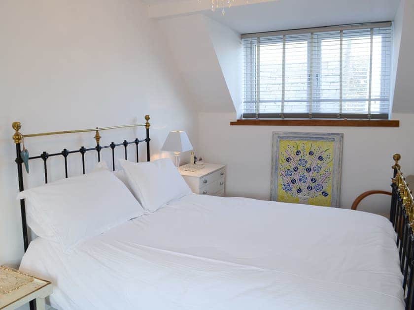 Delightful bedroom with antique style double bed | Sea Thistle Cottage, Nairn