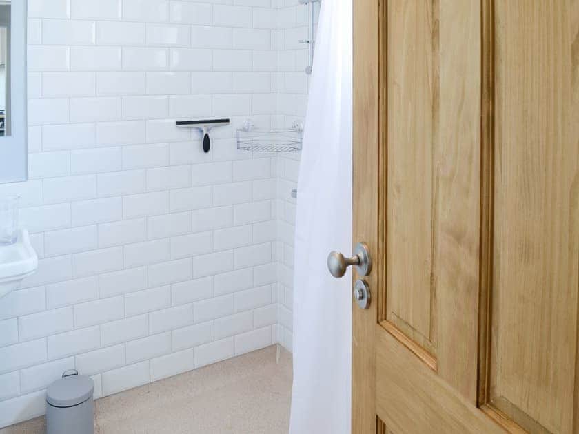 Shower room with open tiled shower area | Sea Thistle Cottage, Nairn