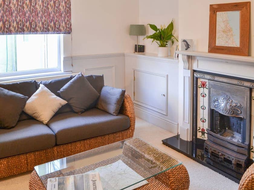 Delightful living room with feature fireplace | Beachcomber Cottage, Newbiggin-by-the-Sea, near Morpeth
