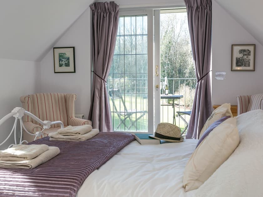 Double bedroom with balcony | Twisly North Lodge, Catsfield, near Battle