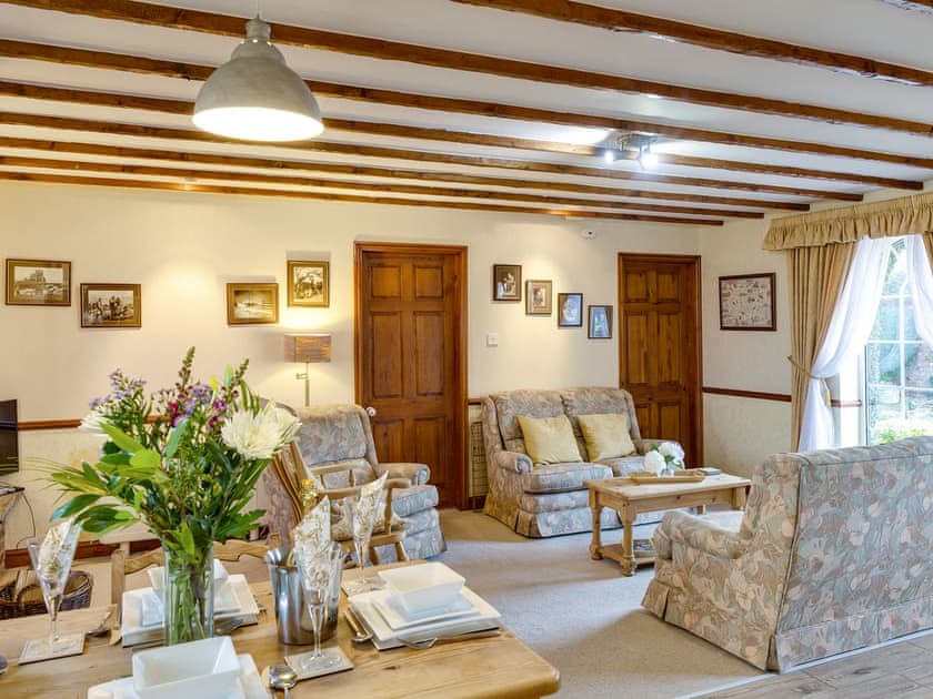 Open plan living space with beamed ceiling | The Old Post Office, Thorpe Bassett, near Malton
