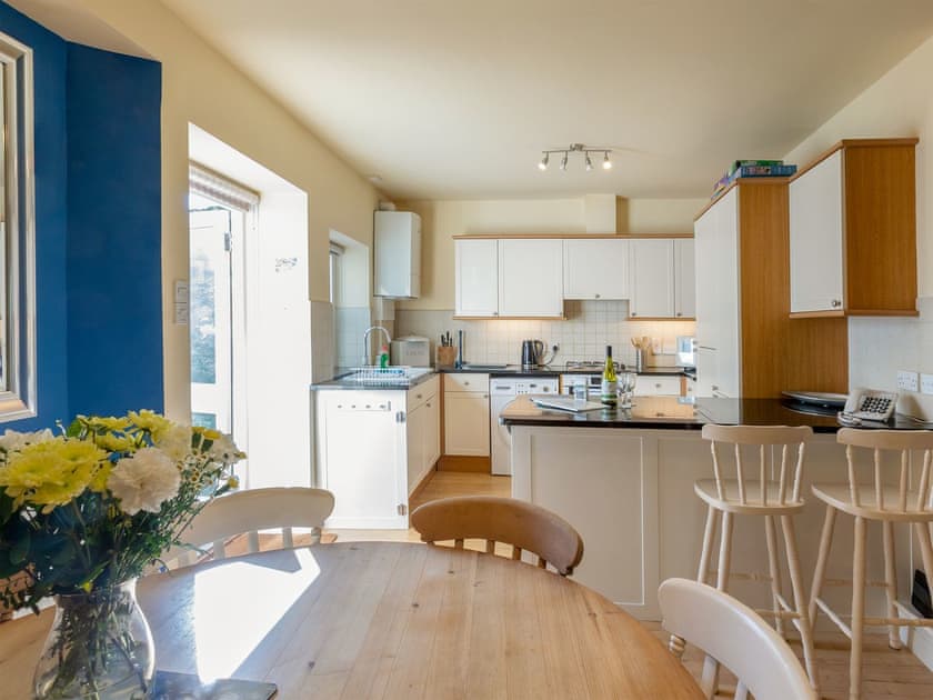 Kitchen with breakfast bar and double doors out to courtyard | Lower Marcam, Salcombe