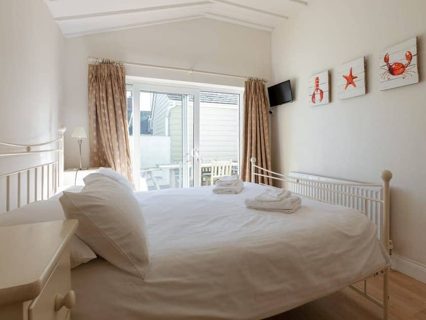 Double bedroom with sliding patio doors out to teak decked terrace | Lower Marcam, Salcombe