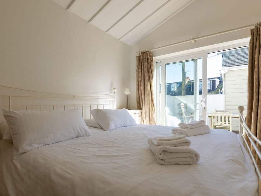 Double bedroom with sliding patio doors out to teak decked terrace | Lower Marcam, Salcombe