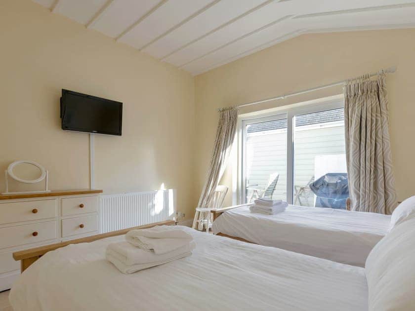 Twin bedroom with stora beds underneath each and sliding patio doors out to teak decked terrace | Lower Marcam, Salcombe