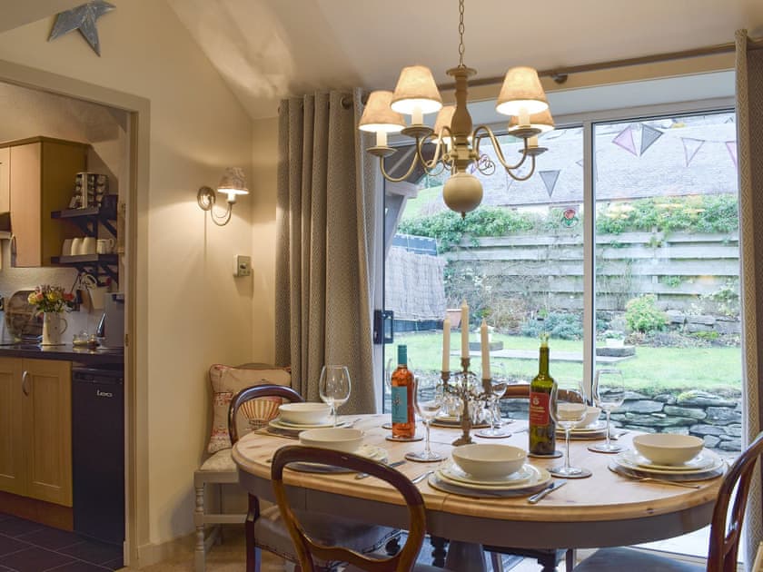 Dining area with patio door to garden | Smiddy Cottage, Weem, near Aberfeldy