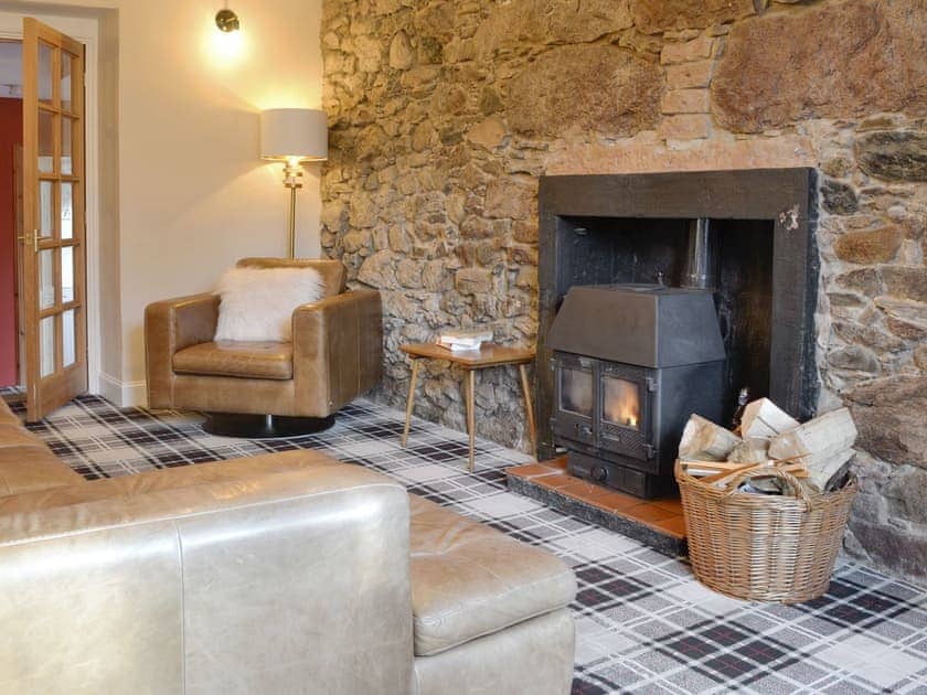 Warming wood burner within living room | Burnbrae Cottage, Bridgend of Lintrathen, near Forfar
