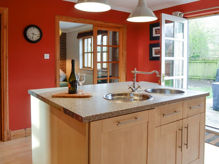 Spacious kitchen with French doors to garden | Burnbrae Cottage, Bridgend of Lintrathen, near Forfar