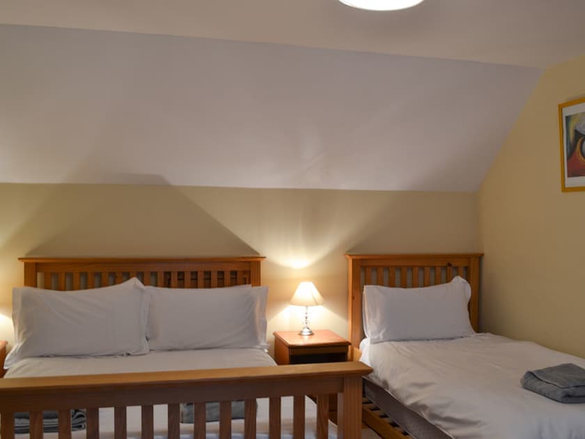 Double bedroom with additional bed | Woodland Lodge, Boat of Garten, near Aviemore