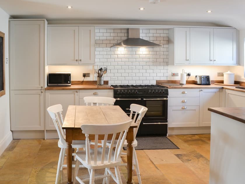 Wooden floored well equipped kitchen diner | Harbourway, Craster