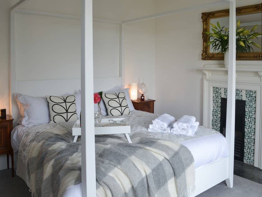 Four poster super-king bedroom overlooking the church and garden  | The Old Vicarage, Talland Bay, near Looe