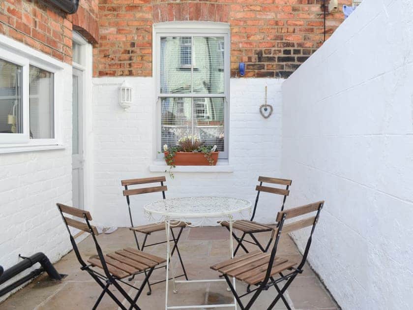 Flagged courtyard garden with sitting out area | Lobster Pot Cottage, Scarborough