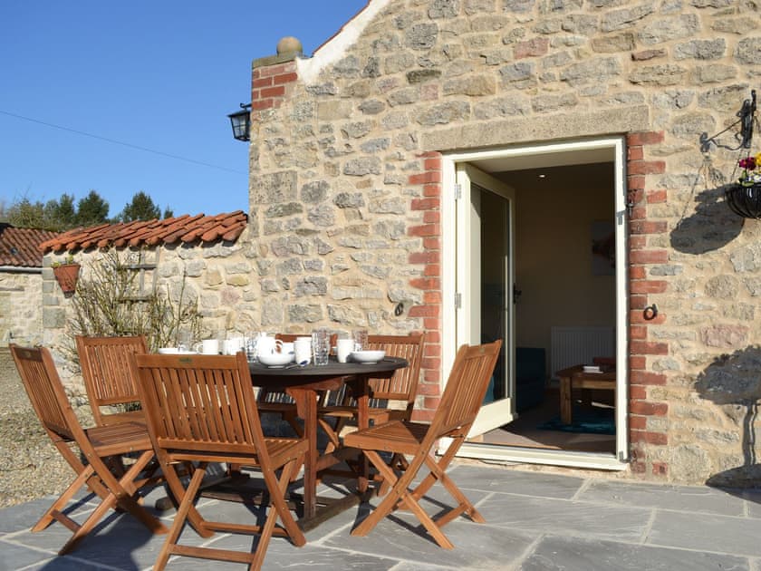 Paved patio with outdoor furniture | Grange Cottage, Harome, near Helmsley
