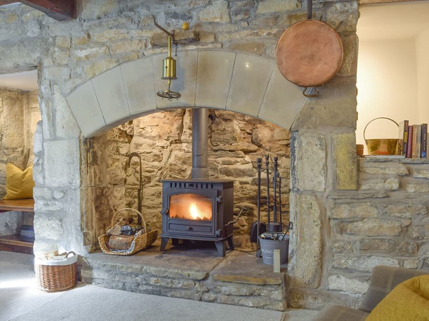 Outstanding stone fireplace with wood burner | Chamber End Fold, Grassington, near Skipton