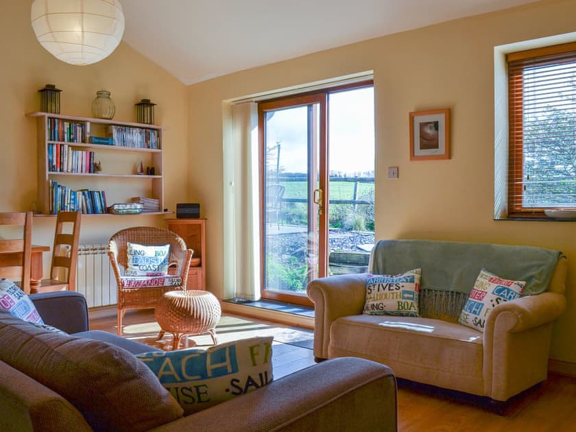 Beautiful living room with patio doors to the garden | Tregella Farm Cottage, Near Padstow