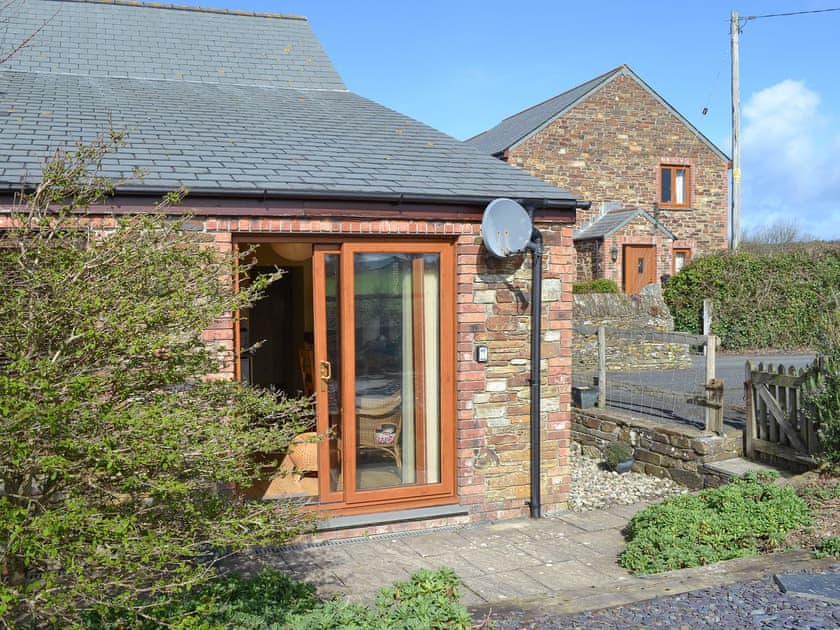 Sunny patio accessed directly from the living room | Tregella Farm Cottage, Near Padstow