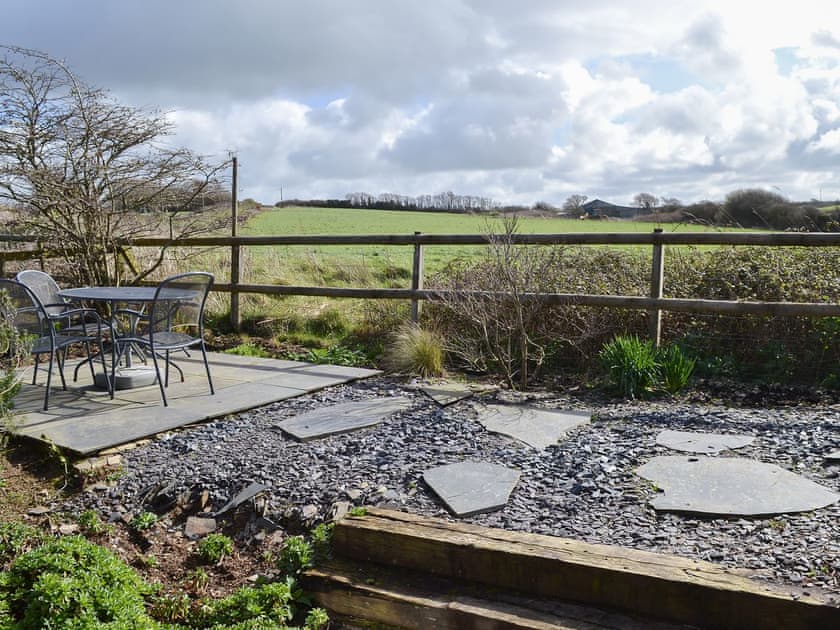 Sunny seating area overlooking open countryside | Tregella Farm Cottage, Near Padstow